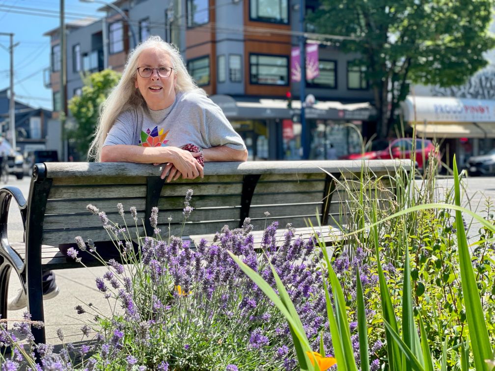 Sherry Loof, lead volunteer gardener of our community, enjoying the beautiful flowers at the gardens along Fraser Street & 45th Avenue.